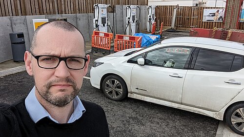 Colin Martin and his EV by a non-functioning charge point